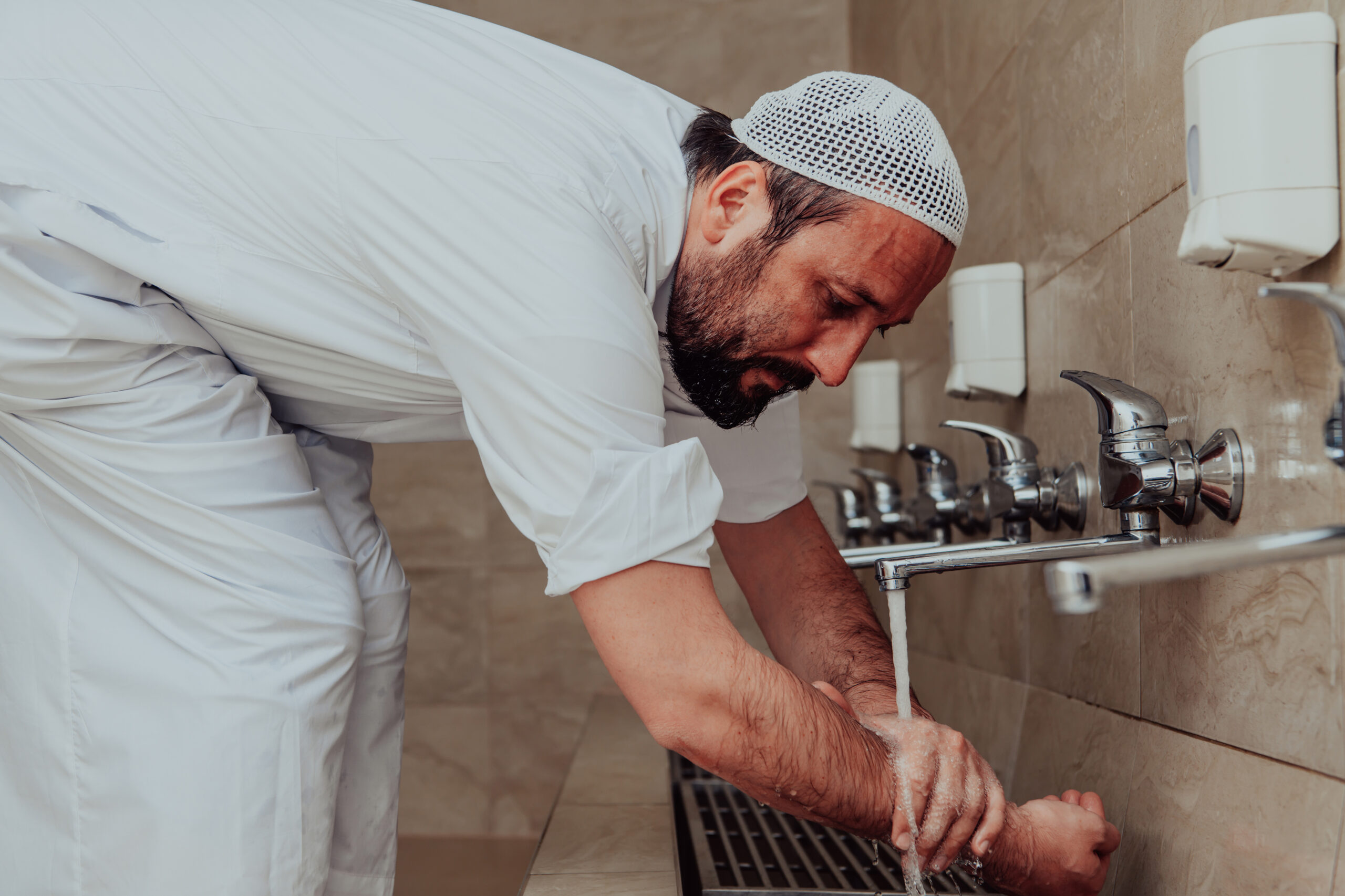 A Muslim performing ablution. Ritual religious cleansing of Muslims before performing prayer. The process of cleansing the body before prayer